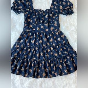 Floral dark blue dress, tight on top, flown on bottom. Ruffles